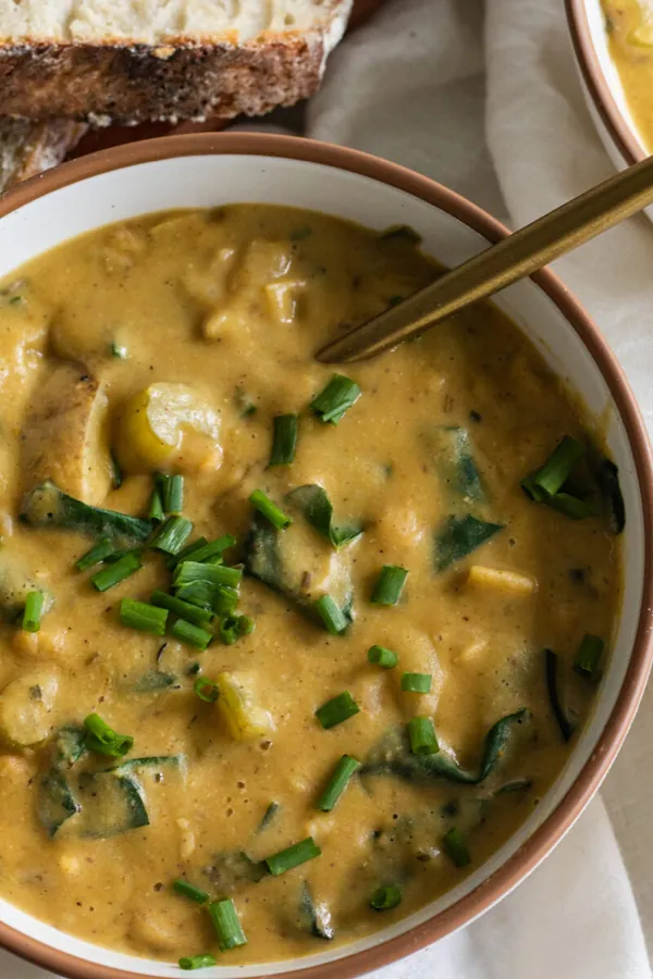 vegan creamy potato soup with beans and spinach